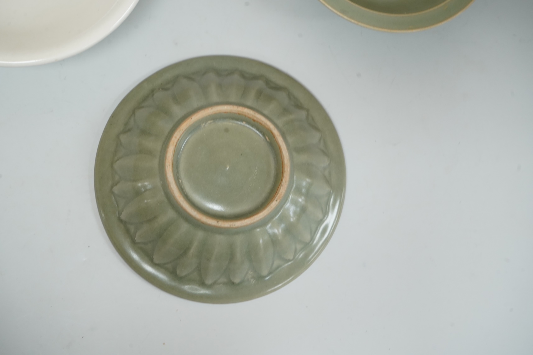 A Chinese celadon glazed twin fish dish, another similar and a white glazed bowl, largest 13.5cm